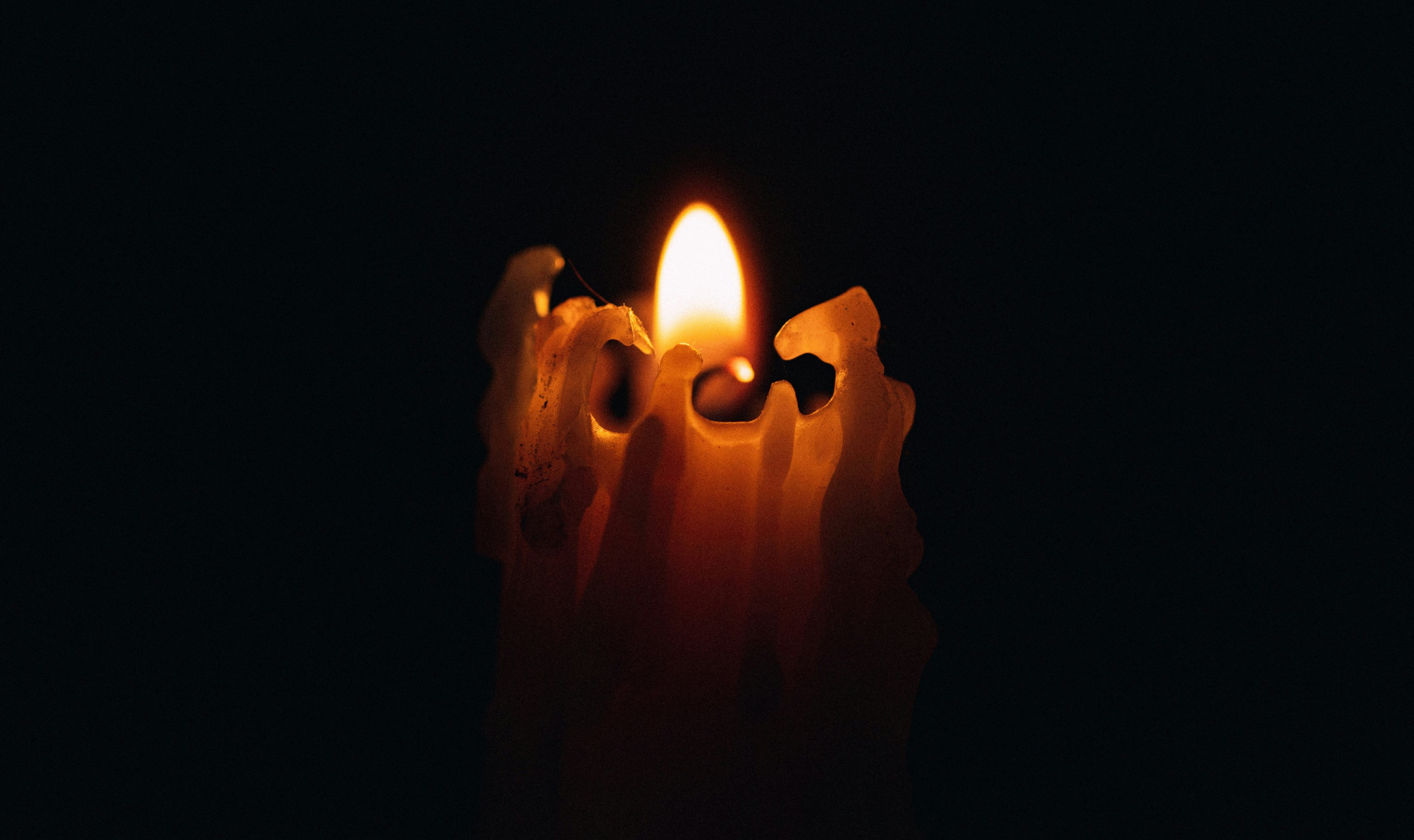 lighted candle in dark room